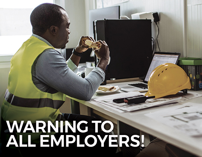 Construction worker enjoys a sandwich during his meal break.